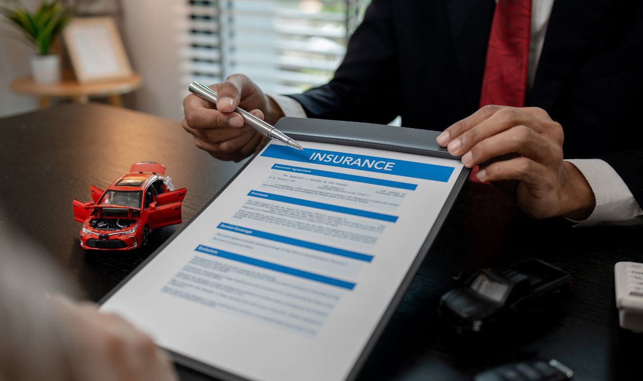 a lawyer is explaining the details of a car insurance policy to the car owner before she signs it, a lawyer explains to his client what will happen if she doesn't get car insurance