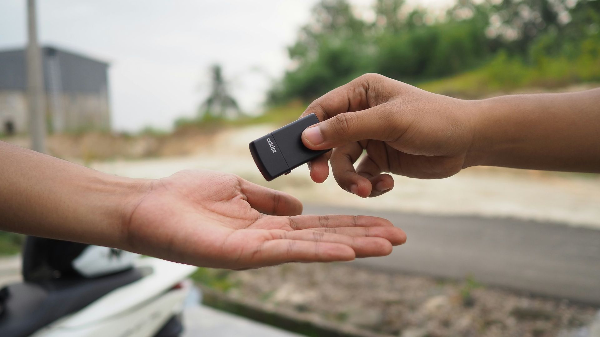 person holding black rectangular device