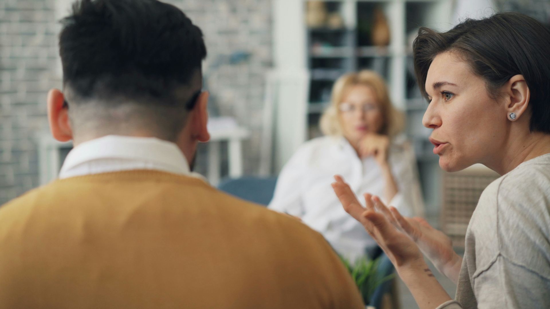 a woman talking to a man at a table
