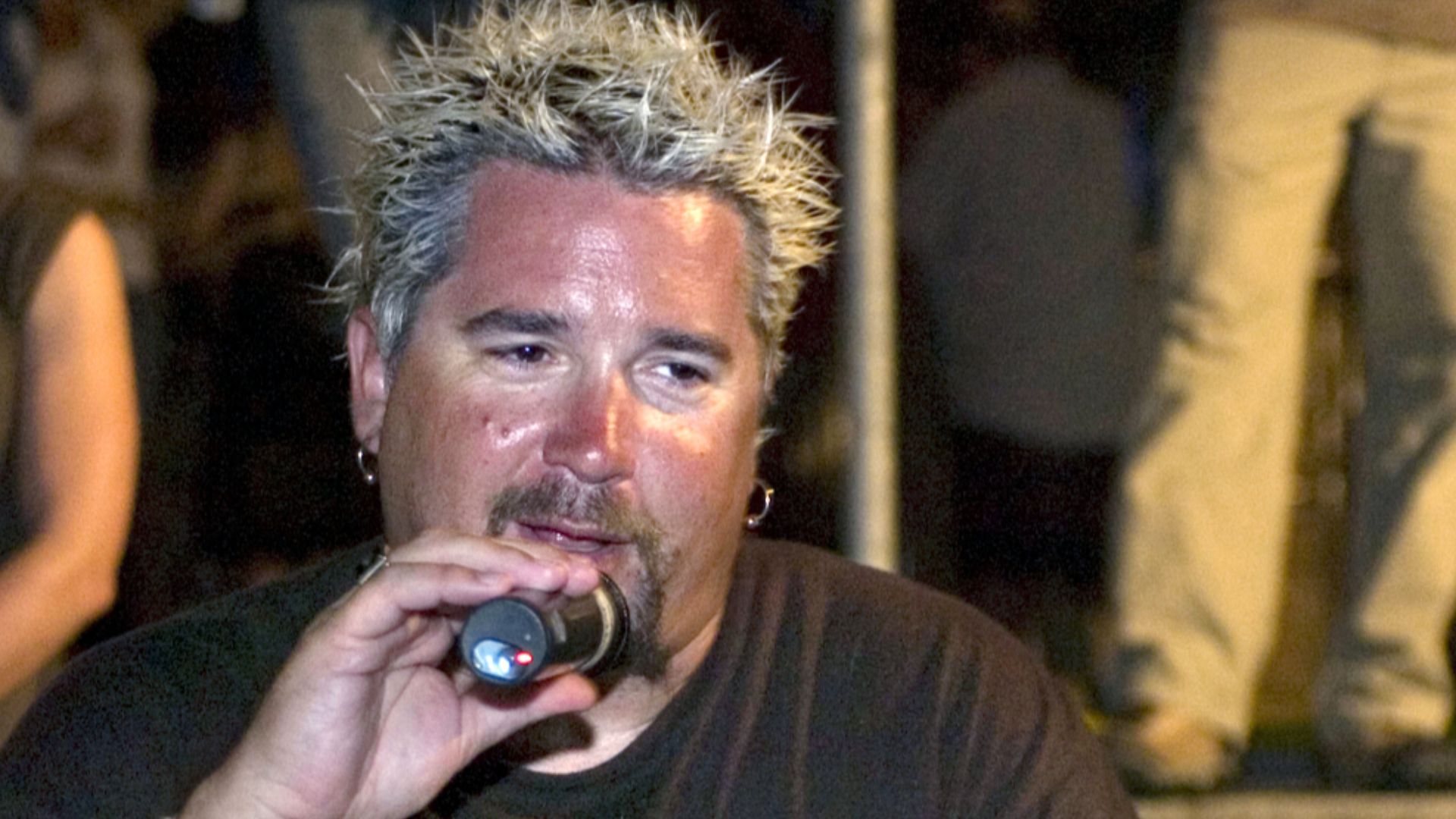 Food Network star Guy Fieri judges a dish during the Iron Chef BBQ Competition at the Tiki Bar Monday.