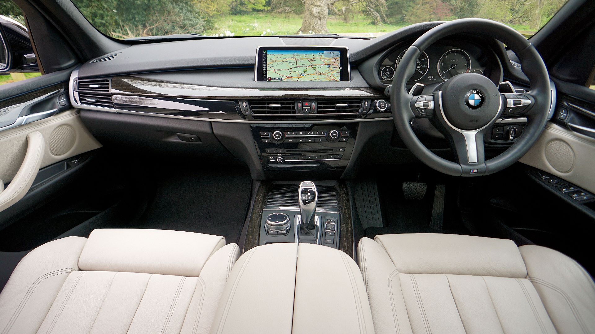 Explore the sleek interior of a BMW featuring a detailed dashboard and GPS navigation system.