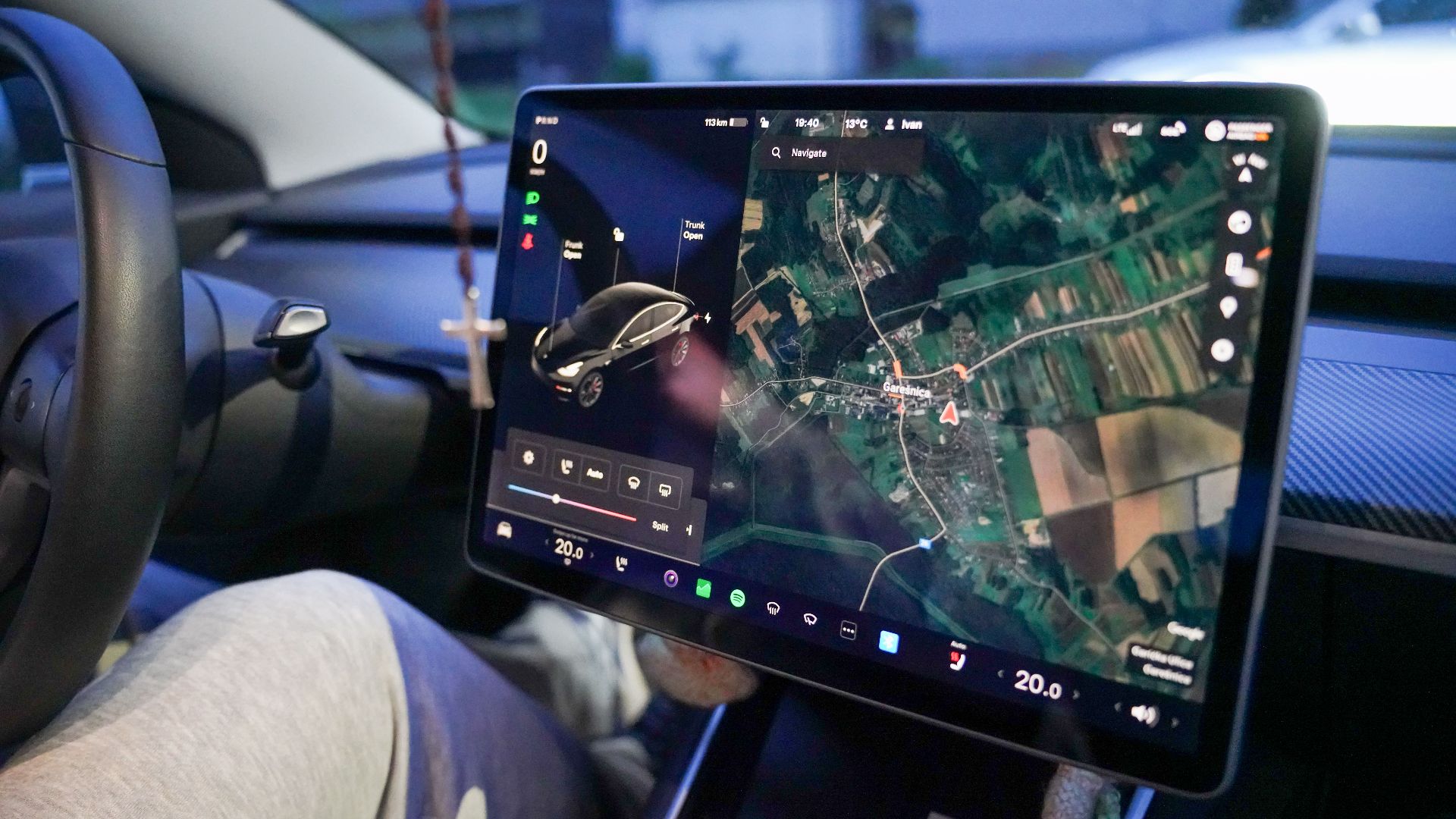 Close-up of a car's digital dashboard displaying GPS navigation in Garešnica, Croatia.
