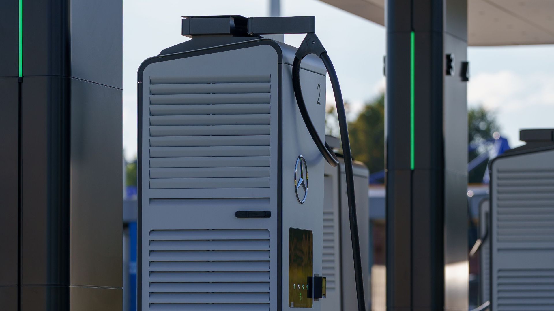 Outdoor electric vehicle charging station with multiple charging units under a canopy.