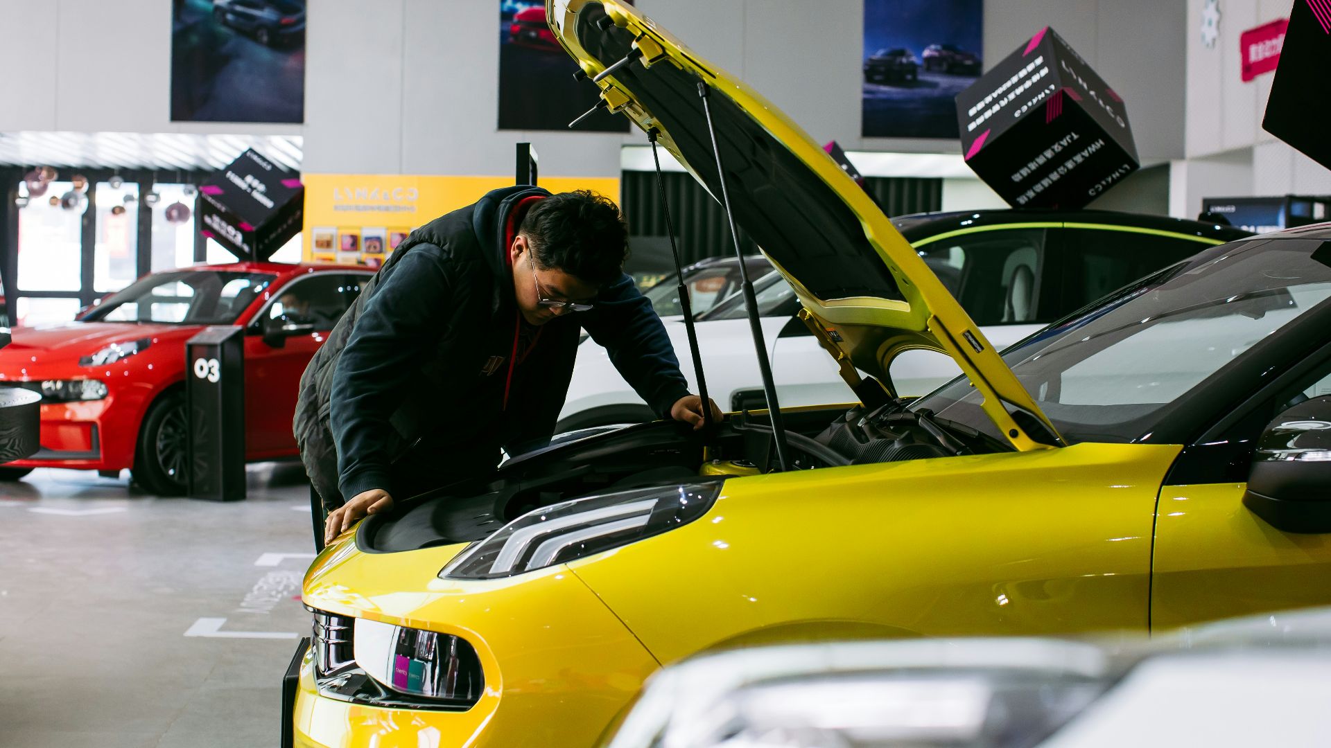 man in black jacket and black pants riding yellow car