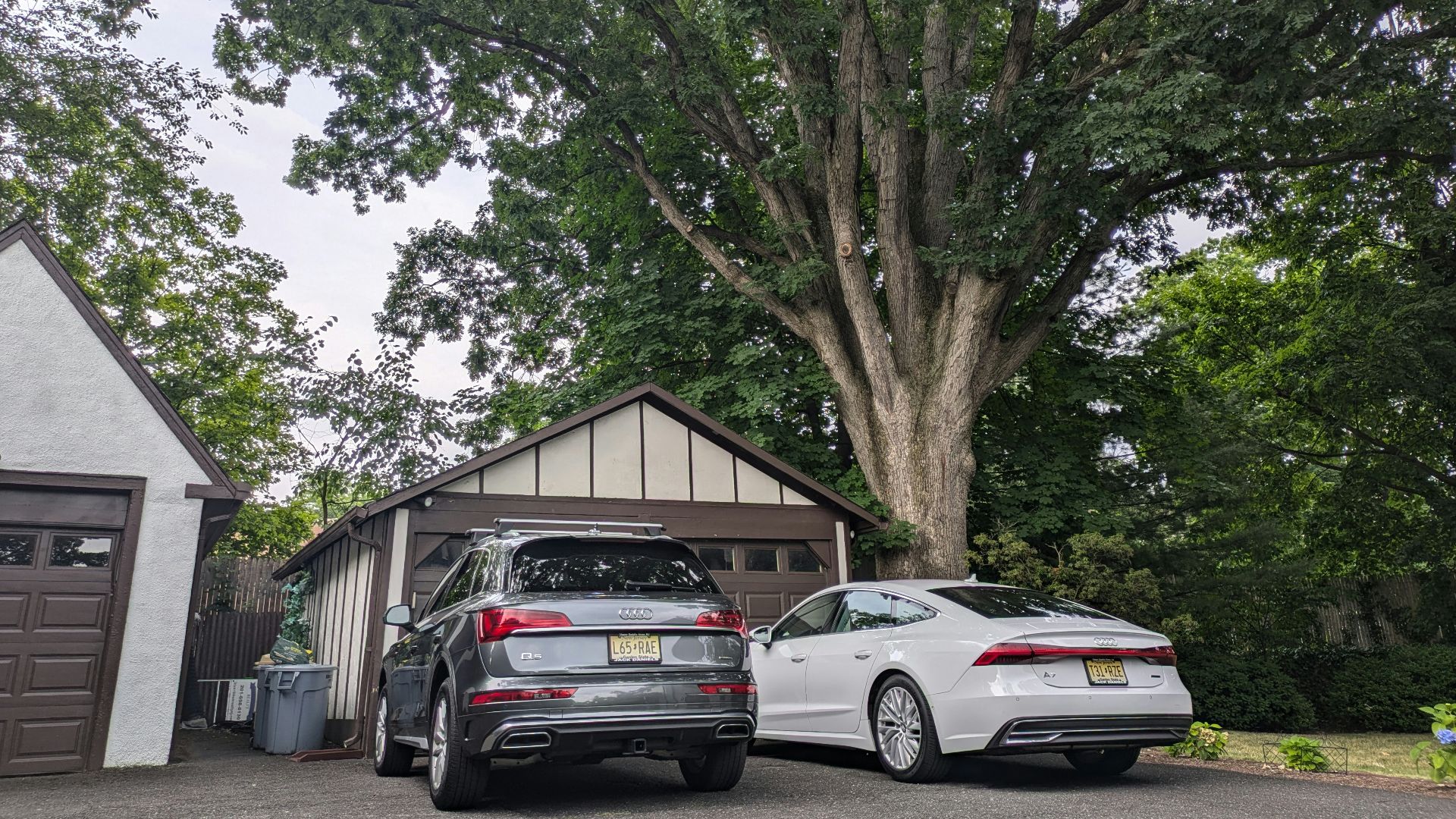 Two cars parked in front of a garage
