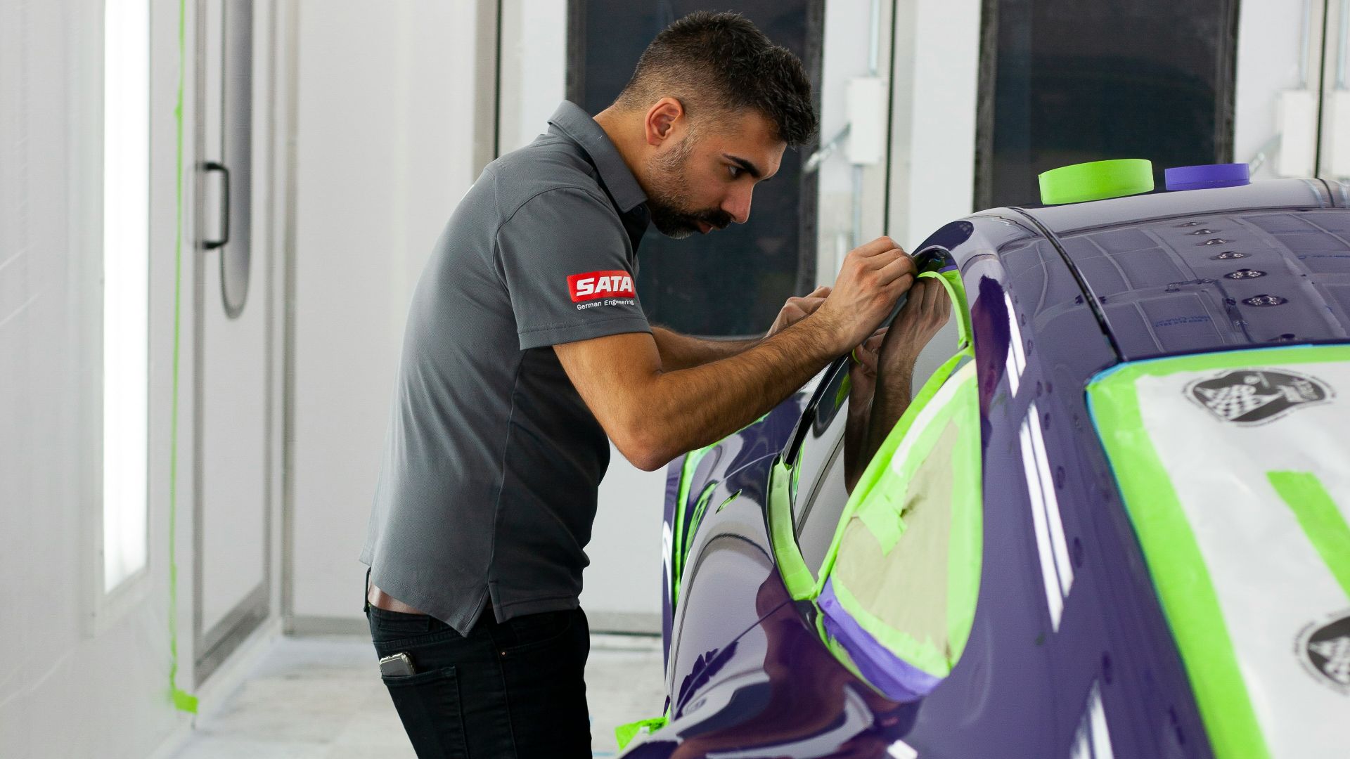 a man working on a car in a garage
