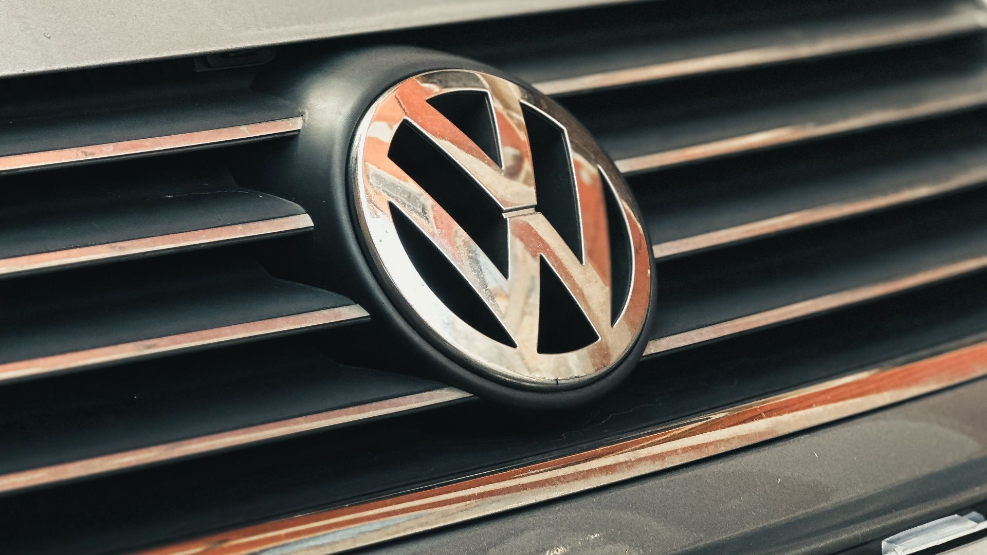 Close-up view of Volkswagen car grille and European license plate, highlighting details.