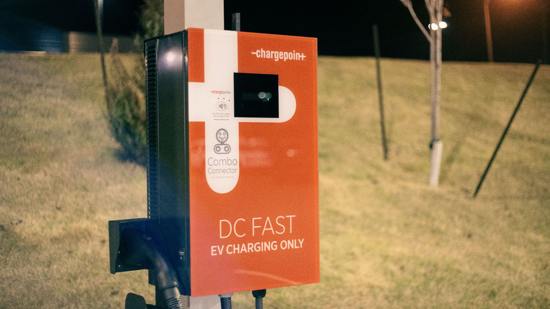 Electric recharging point for vehicles working on eco friendly energy source against hill on roadside at night