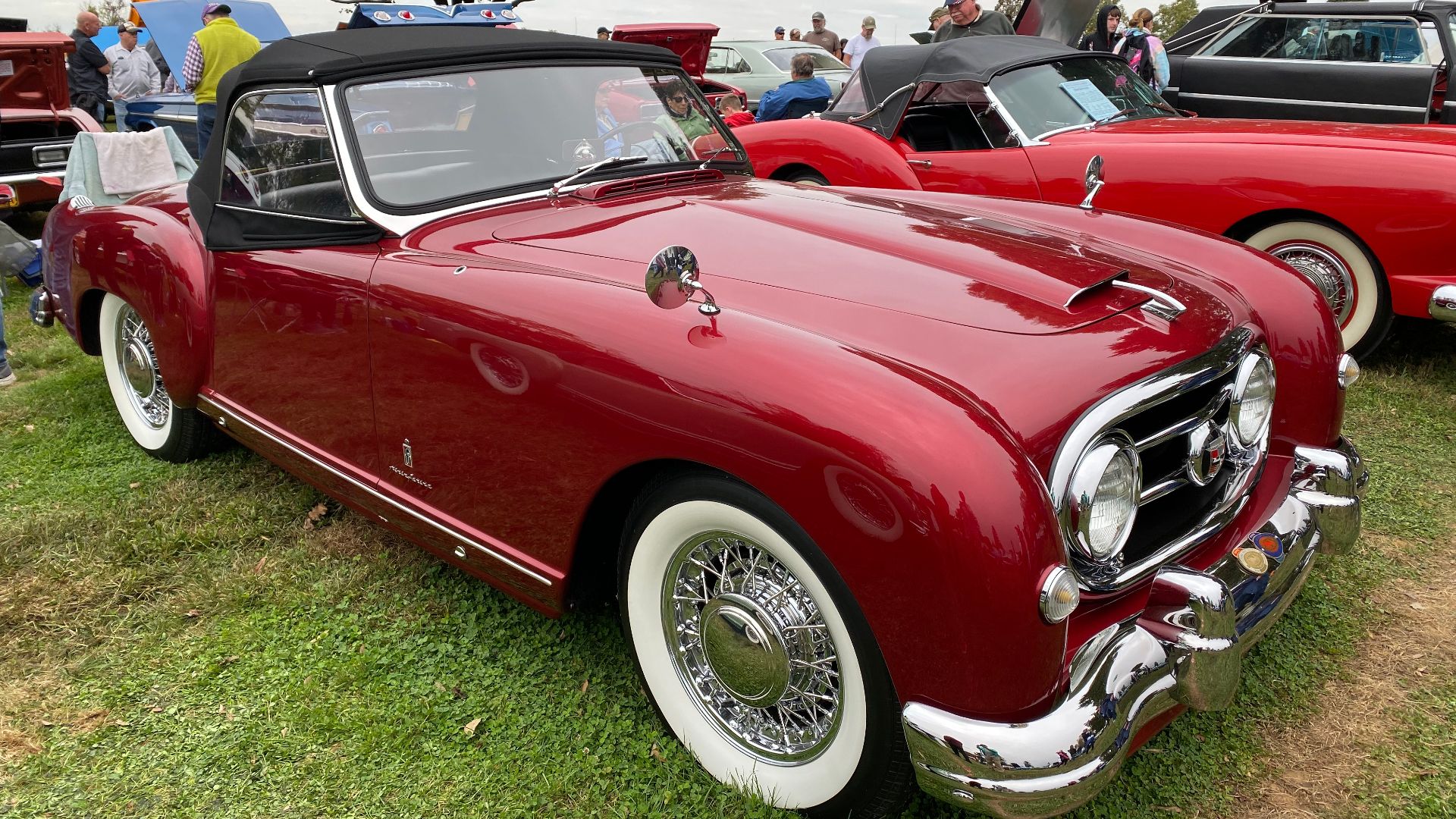 1953 Nash-Healey convertible roadster in red burgundy with a black top on the show field during the 2019 AACA meet in Pennsylvania. The two-seat sports car was produced for the American market between 1951 and 1954. Marketed by Nash Motors (merged into A