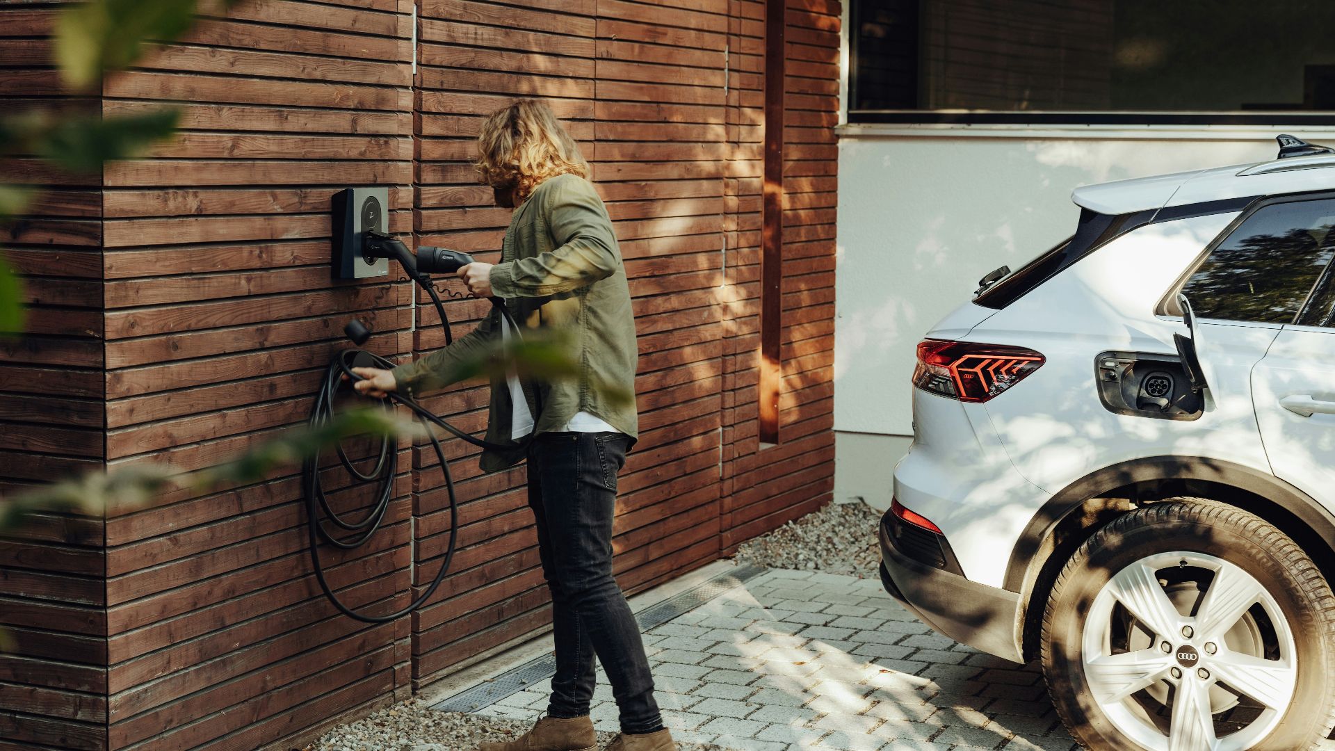 a woman is using a power washer on a brick wall