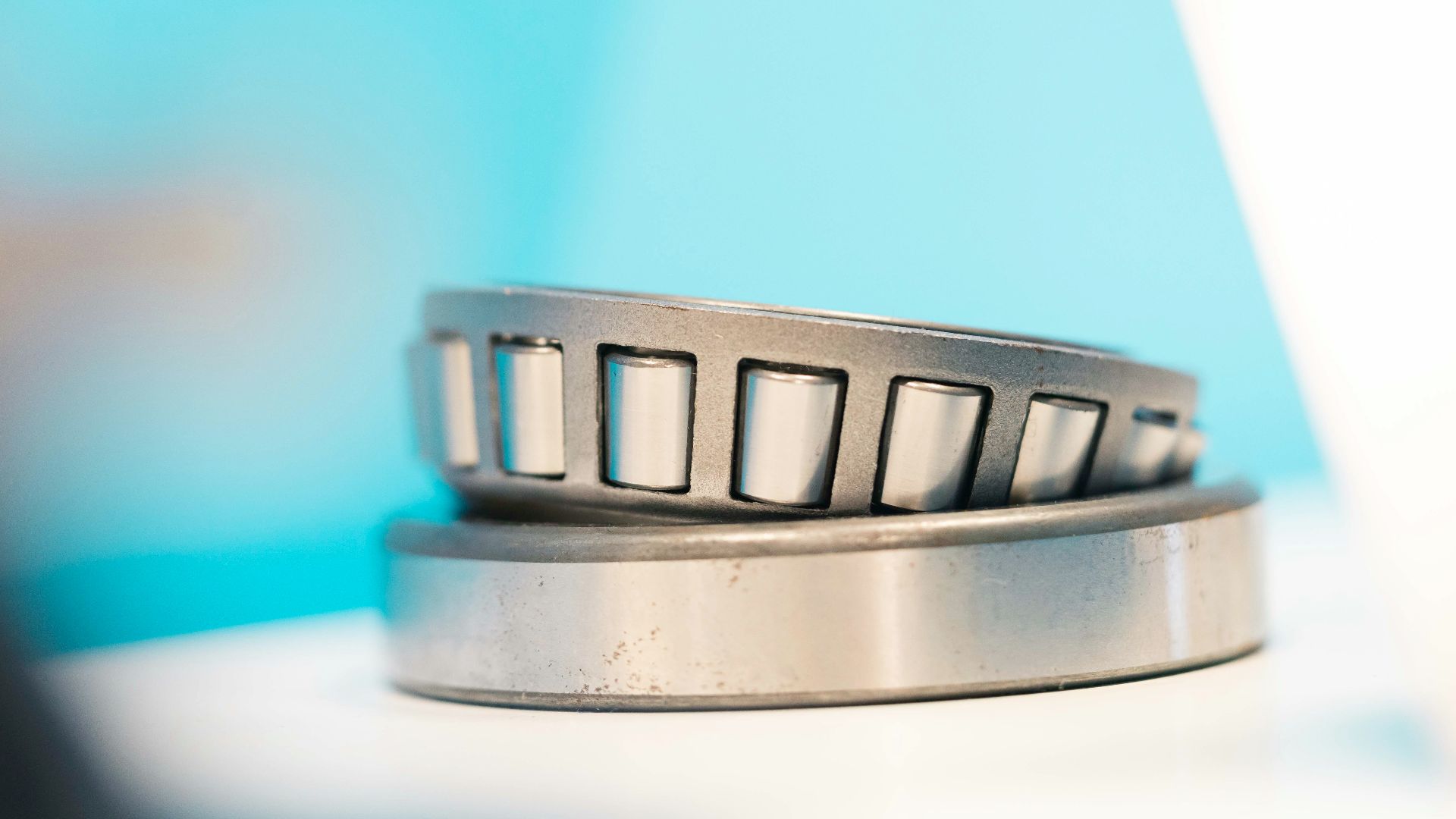 a close up of a metal object with a blue background