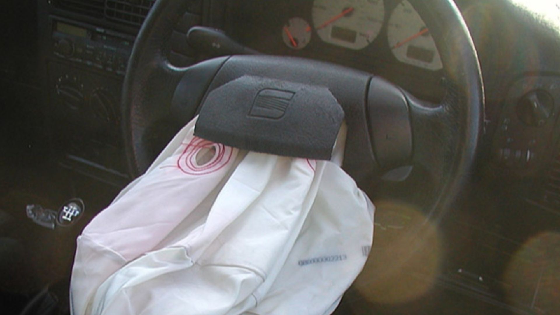 The airbag of a SEAT Ibiza automobile, photographed about an hour after the car had been severely damaged in a road crash.
By 0.3 seconds after inflation, the bag is supposed to be empty.[1]
The driver crashed into the back of a Mercedes in a queue of tra