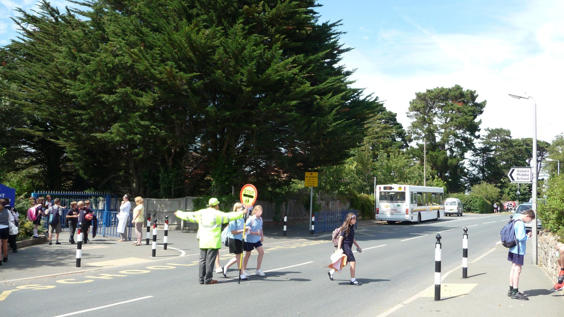 A typical school scene, with Wightbus 5804 (HW54 DCO), a Dennis Dart SLF/Plaxton Pointer 2, in Baring Road, Cowes, Isle of Wight. It is picking up school children at Solent Middle School, on route 135 (though is showing the wrong number) to Newton via Tho