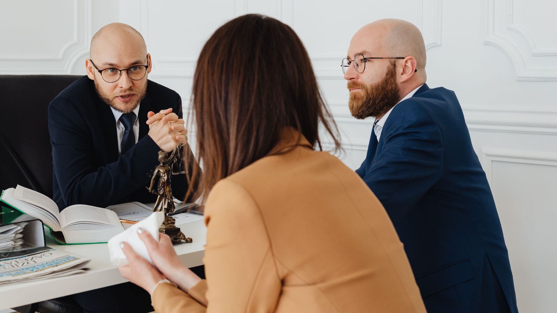 Professional discussion among lawyers in a modern office, focusing on legal matters.