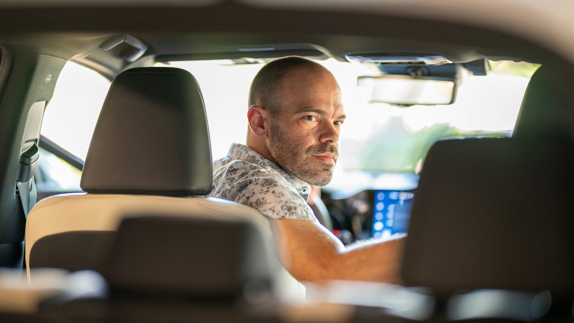 a man sitting in the passenger seat of a car