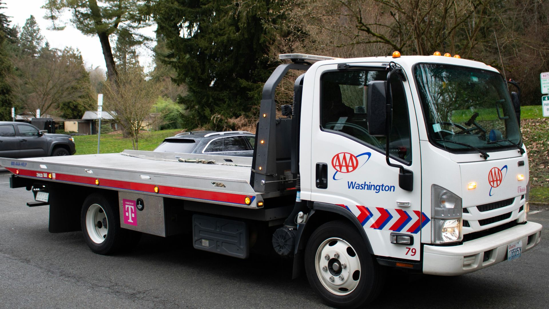 A tow truck is driving on a street