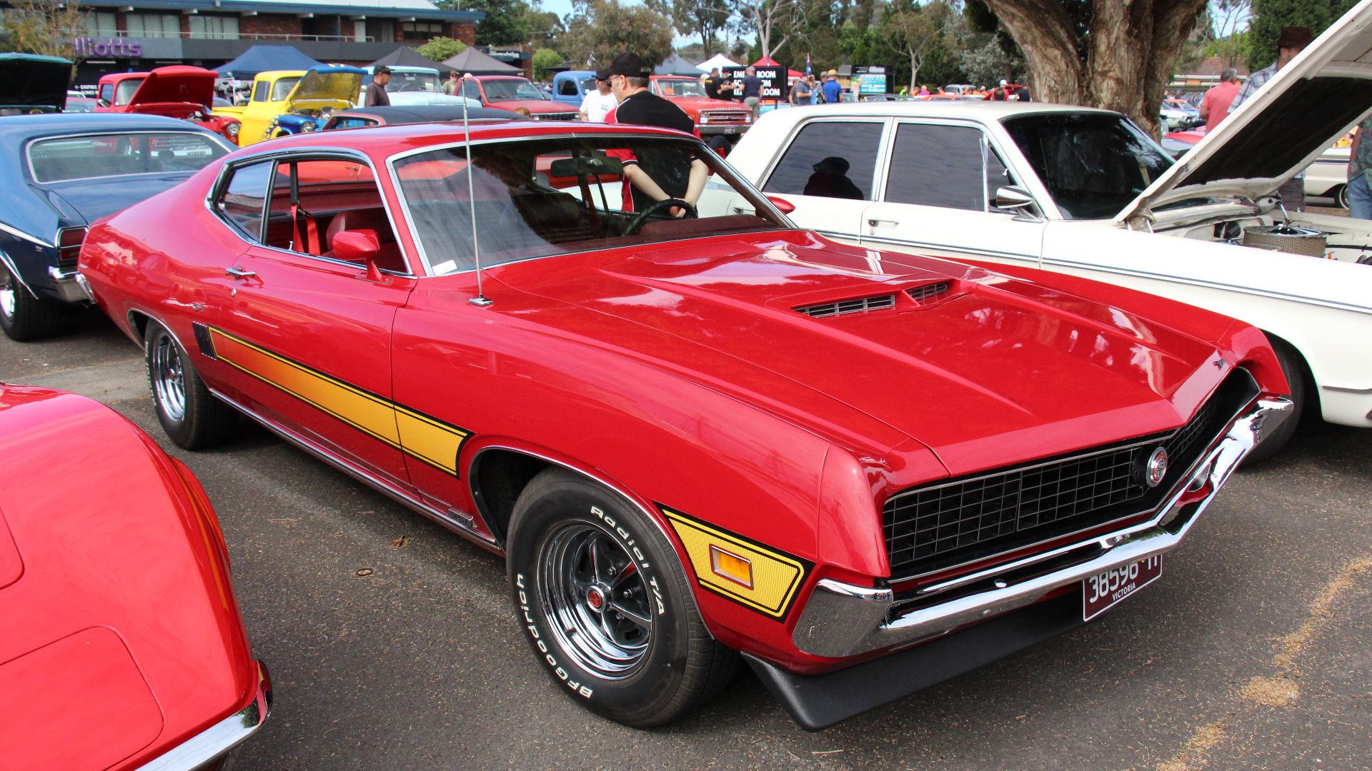 Candyapple Red 
The Ford Torino was built from 1968-76. 
Styling for the 1970-71 Torino was completely redesigned to a more coke bottle style with bulging rear quarters. It got a full width grille surrounding quad headlights 
In 1971 the grilles got a cen