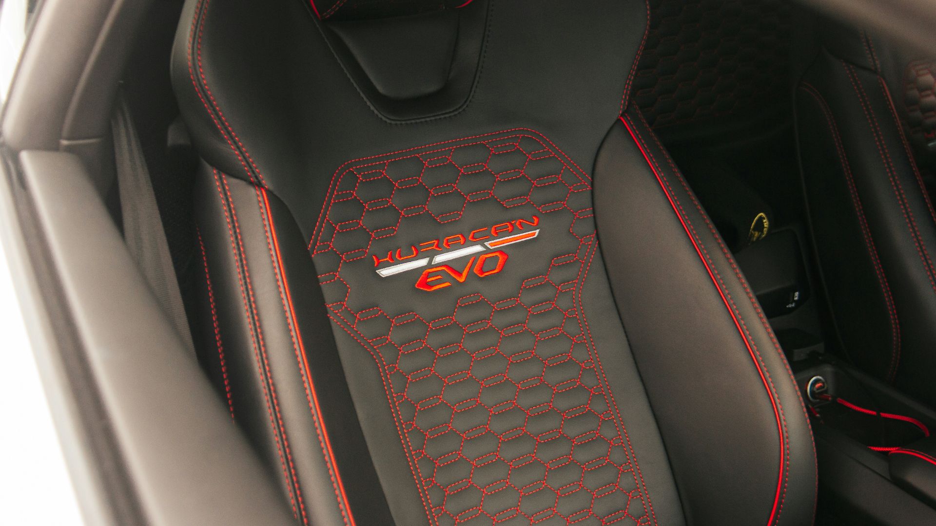 a close up of a car's interior with red stitching