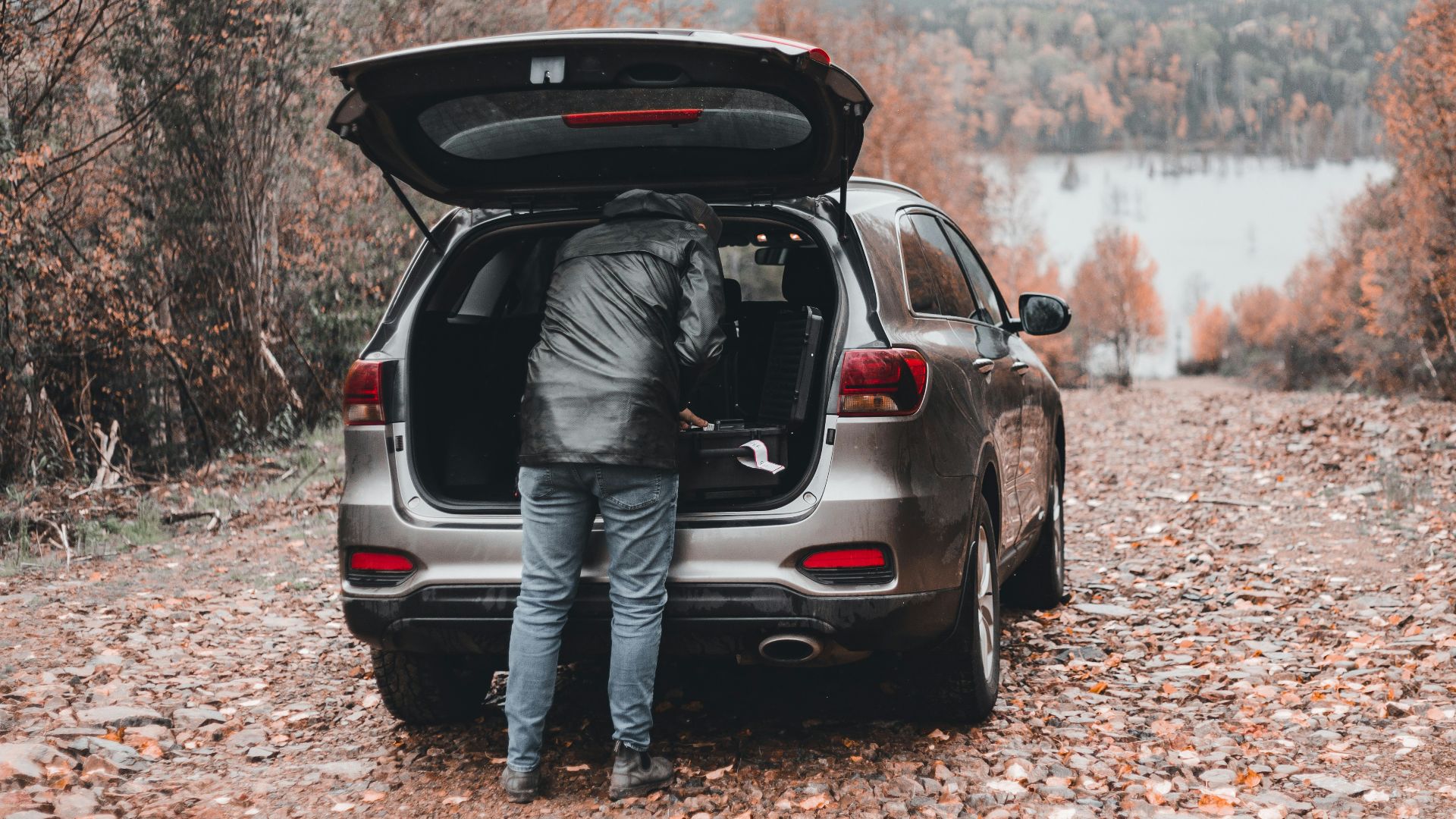 a person standing in the trunk of a car