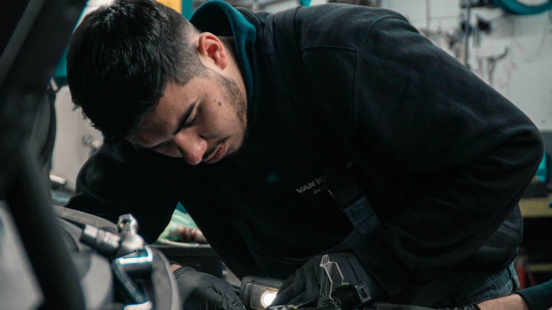 mechanic working on car engine
