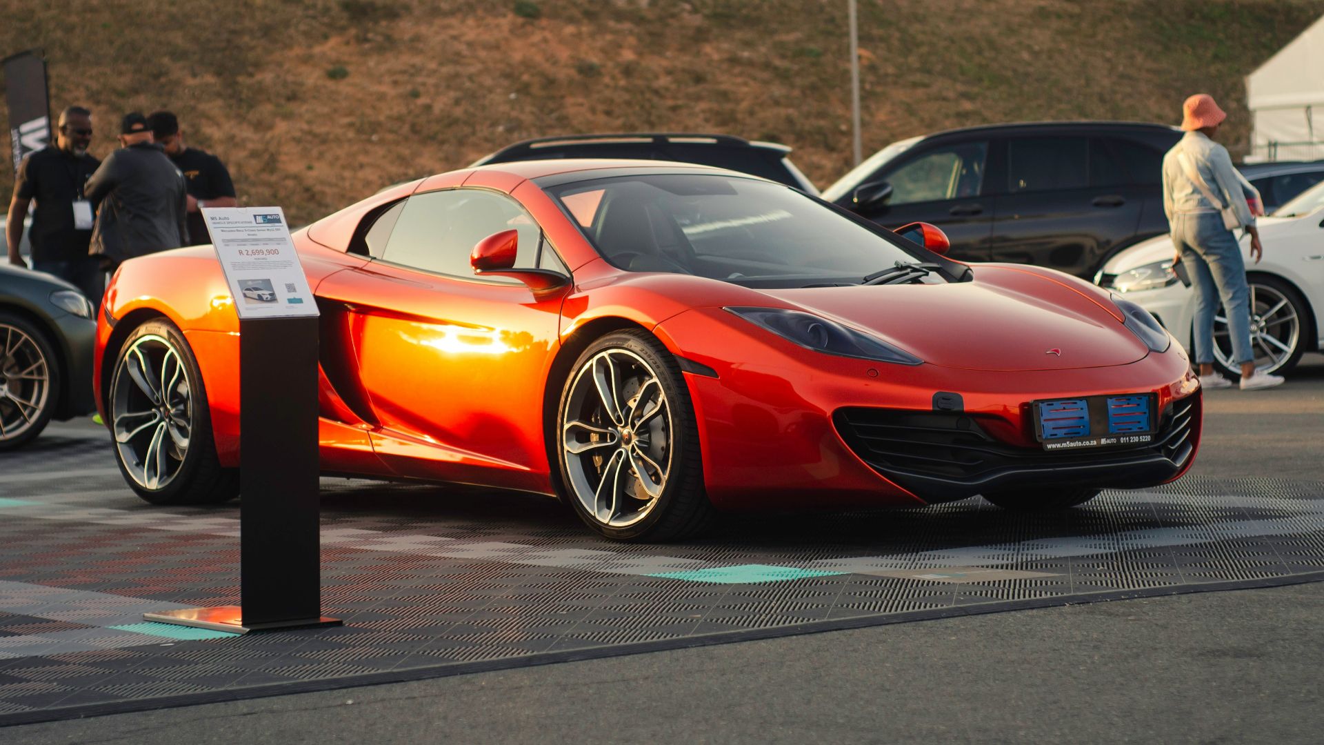 an orange sports car parked in a parking lot