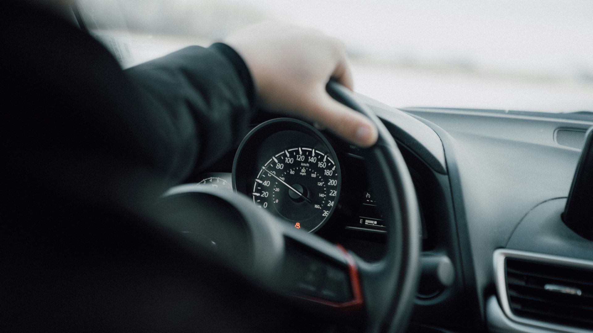 person in black long sleeve shirt driving car