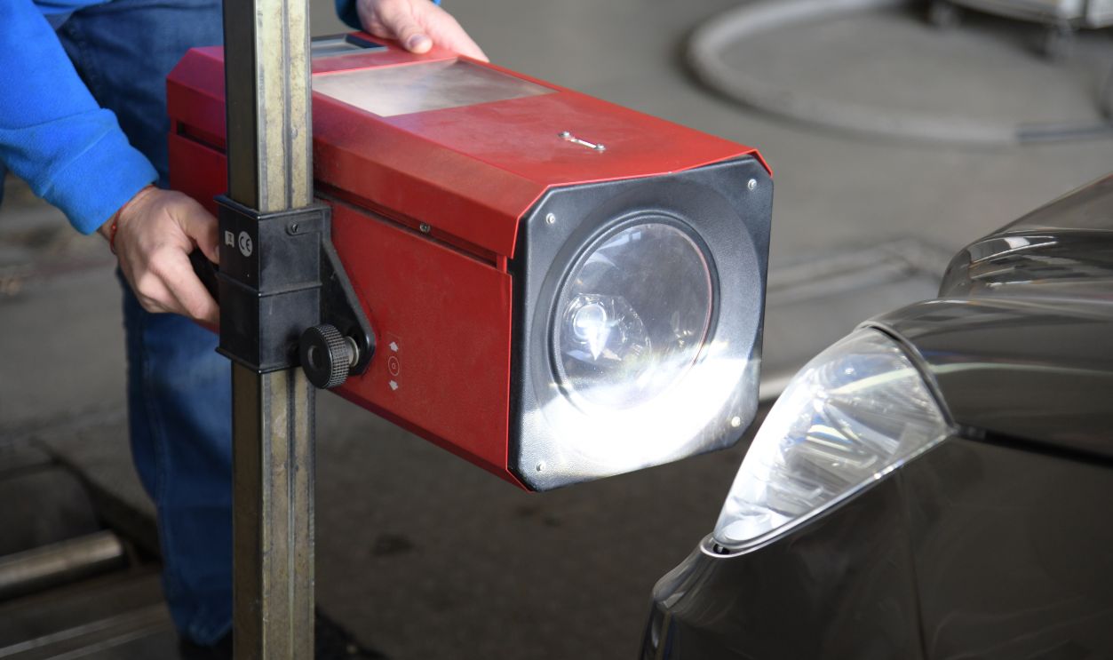 Shutterstock-2235249701, Sofia, Bulgaria - Nov 7 2022: Worker checks the headlights of a car's lighting system during an annual car inspection