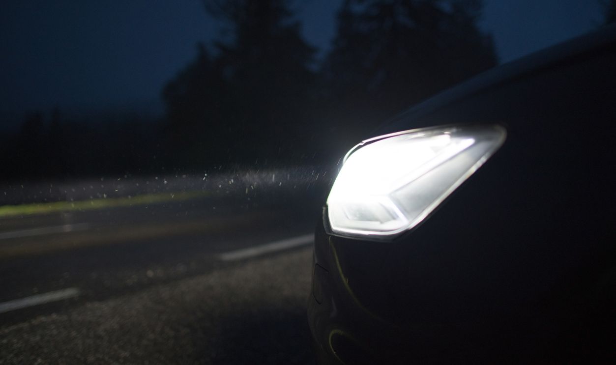 Bright Car Headlights Night Time Drive. Clean Vehicle Headlights and Driving Safety Concept Photo.