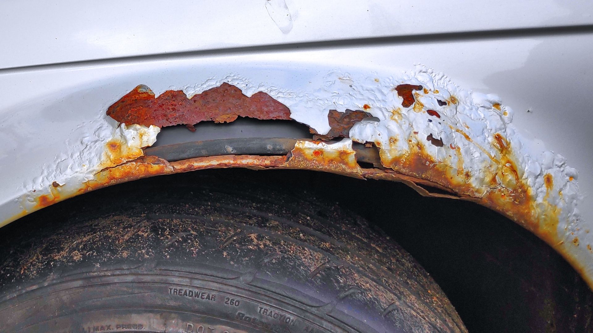 Car bodywork rusted through. Rust bubbles on silver BMW 318i (E46).