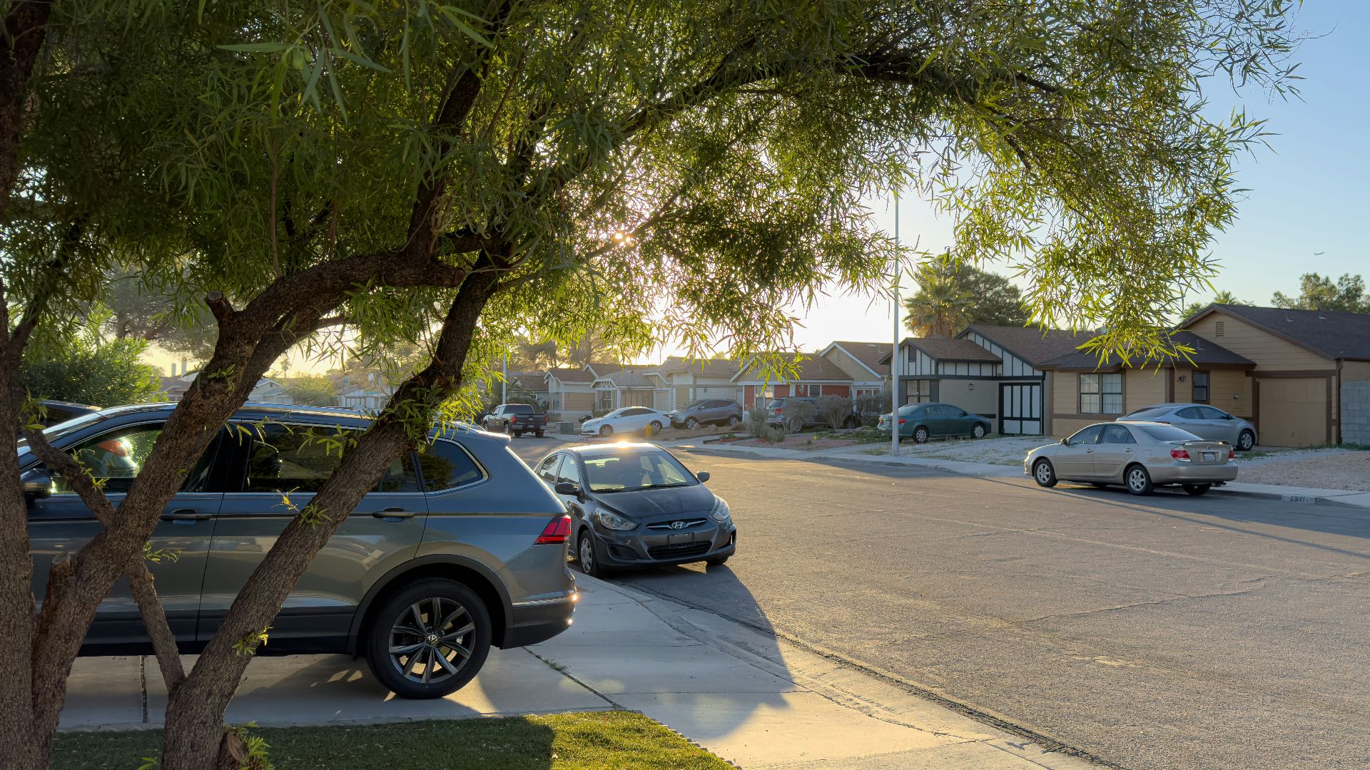 a couple of cars parked on the side of a road