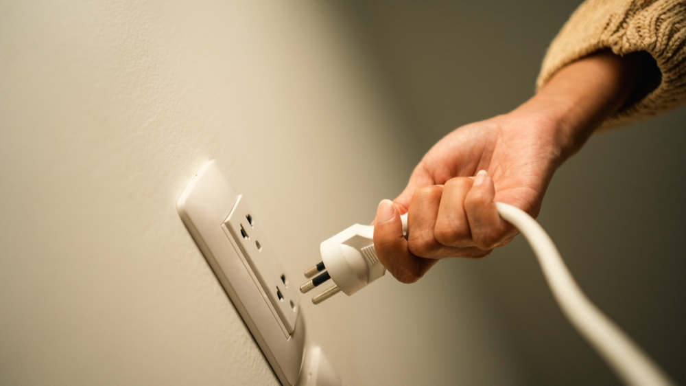 Close up woman hand put on or remove Electric plug cable