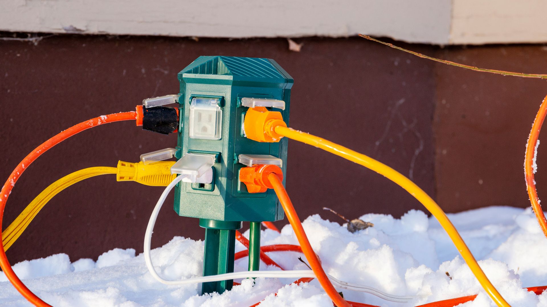 a couple of orange and yellow wires connected to a light switch