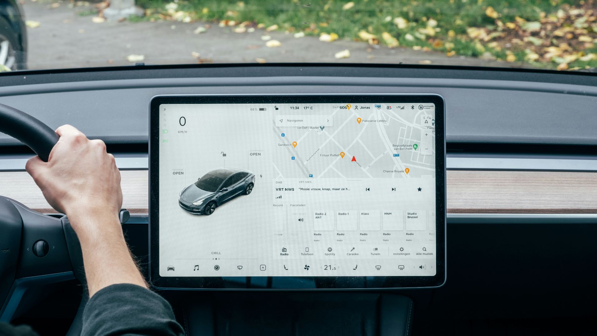 a person driving a car with a computer on the dashboard