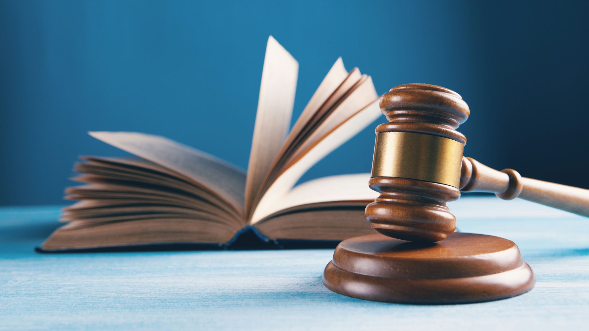 judges gavel and open book on table