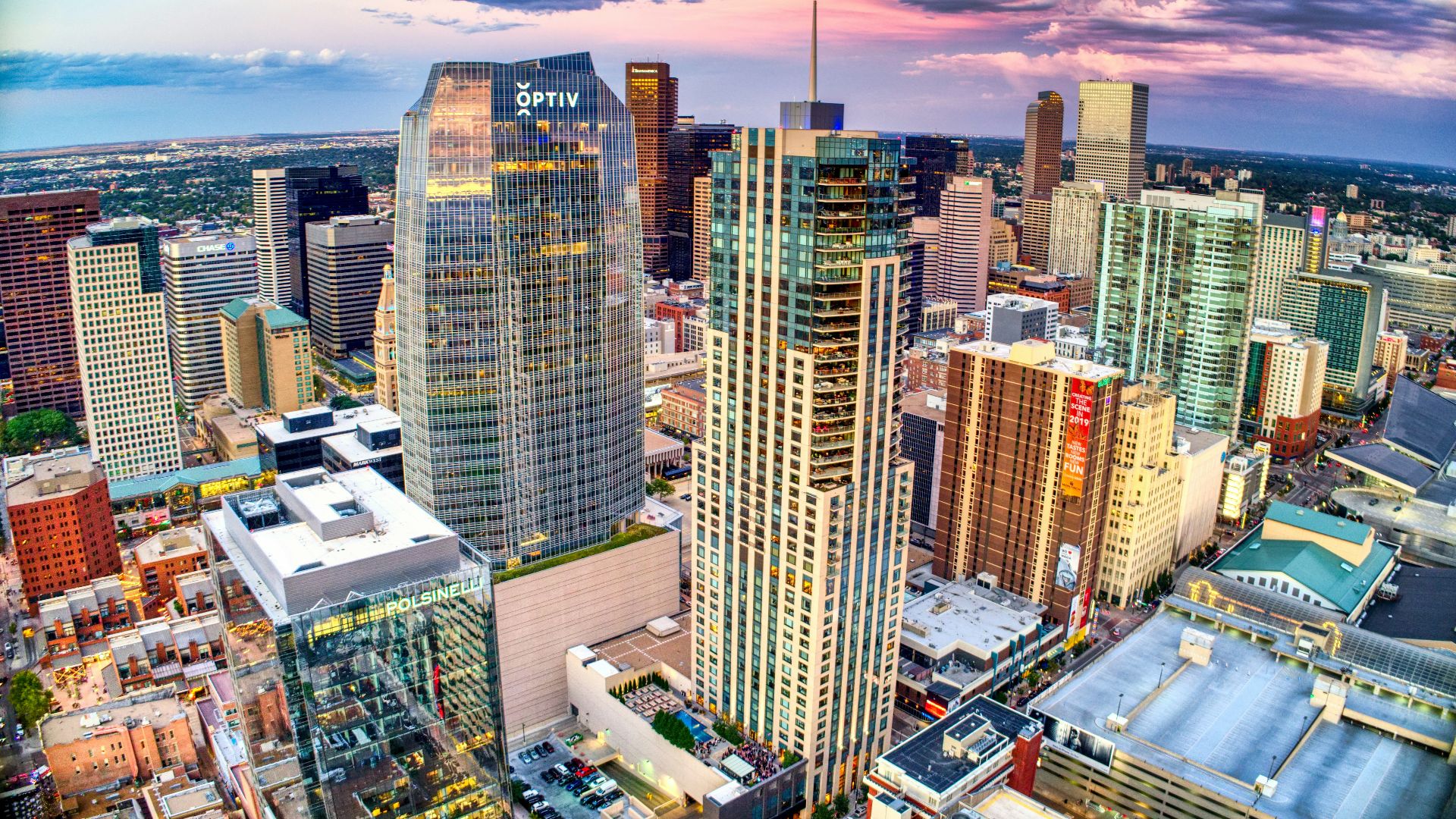 high rise buildings under white clouds and blue sky during daytime