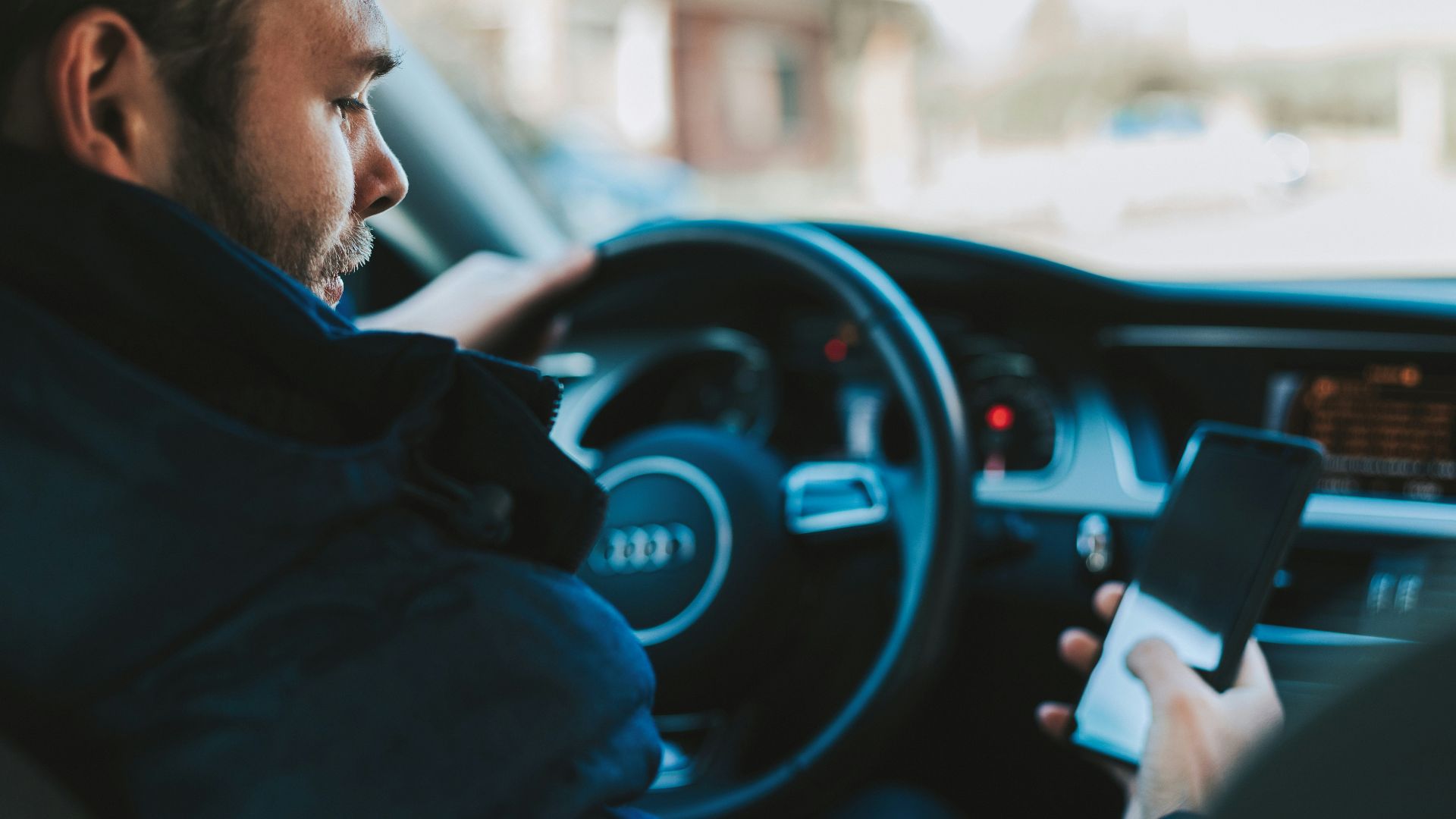 man holding black smartphone