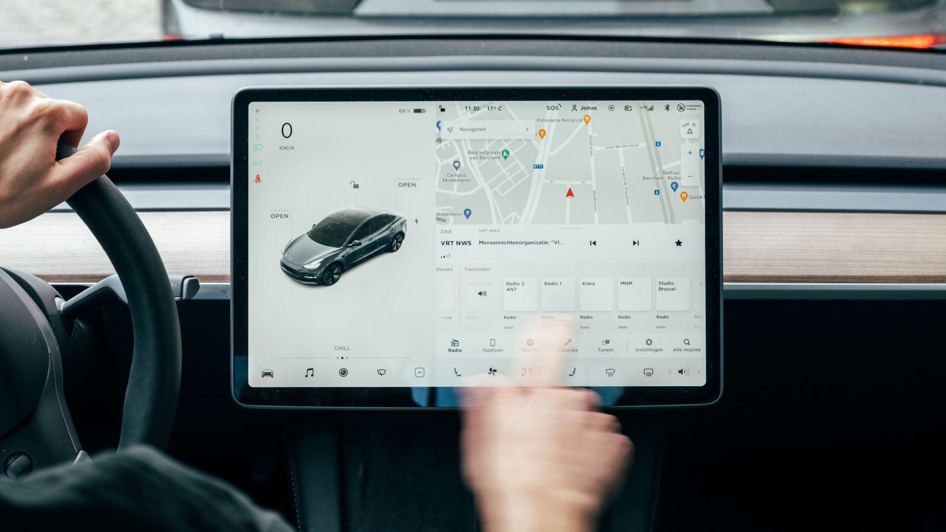 a person driving a car while holding a tablet