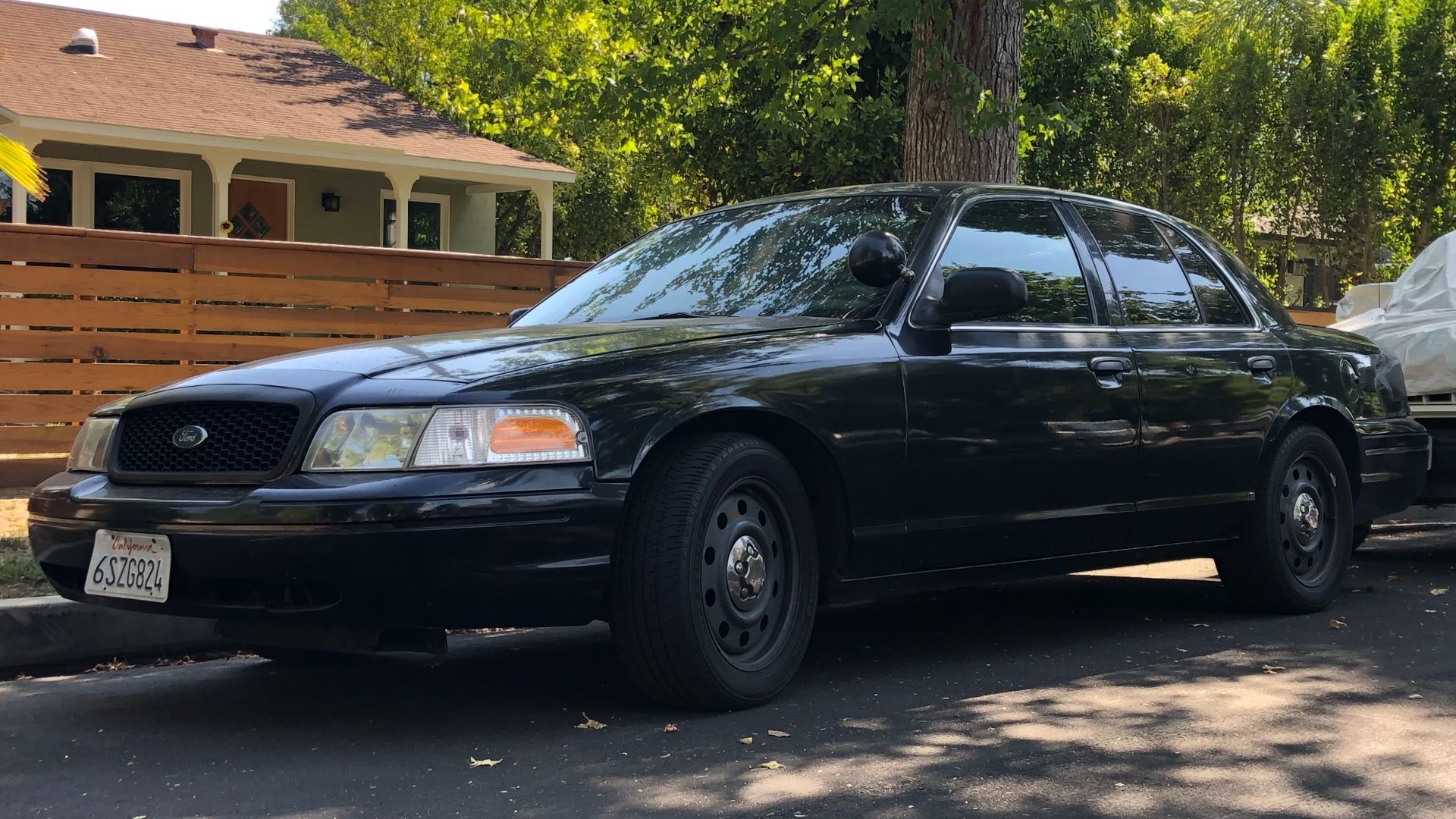 A black 2006-2011 Ford Crown Victoria Police Interceptor.