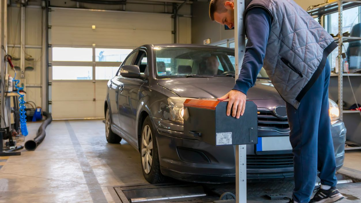 Shutterstock-2566879479, Inspector doing a checking of the headlights with a headlight tester.  Automobile car inspection headlight checkup at repair service station. Technical inspection of cars.