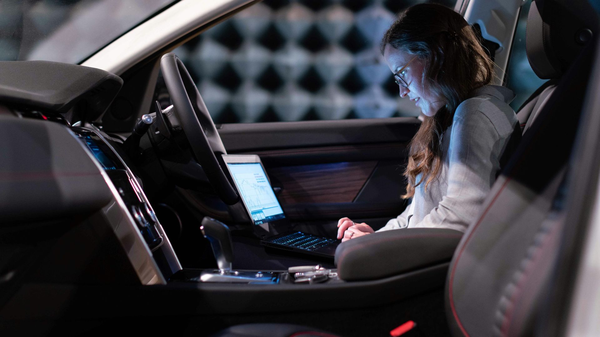 woman in white jacket sitting on car seat