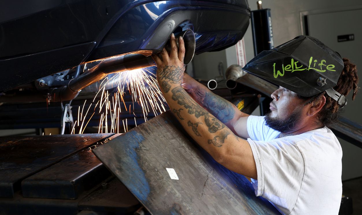 David Leal installs a tailpipe on a vehicle 1481730432