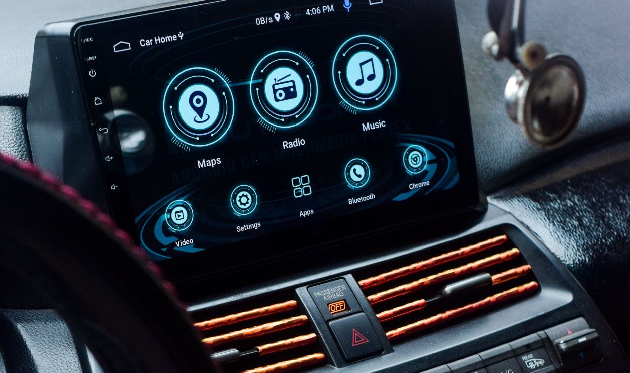 Detailed view of a car dashboard with a digital touchscreen display showing maps, radio, and music options