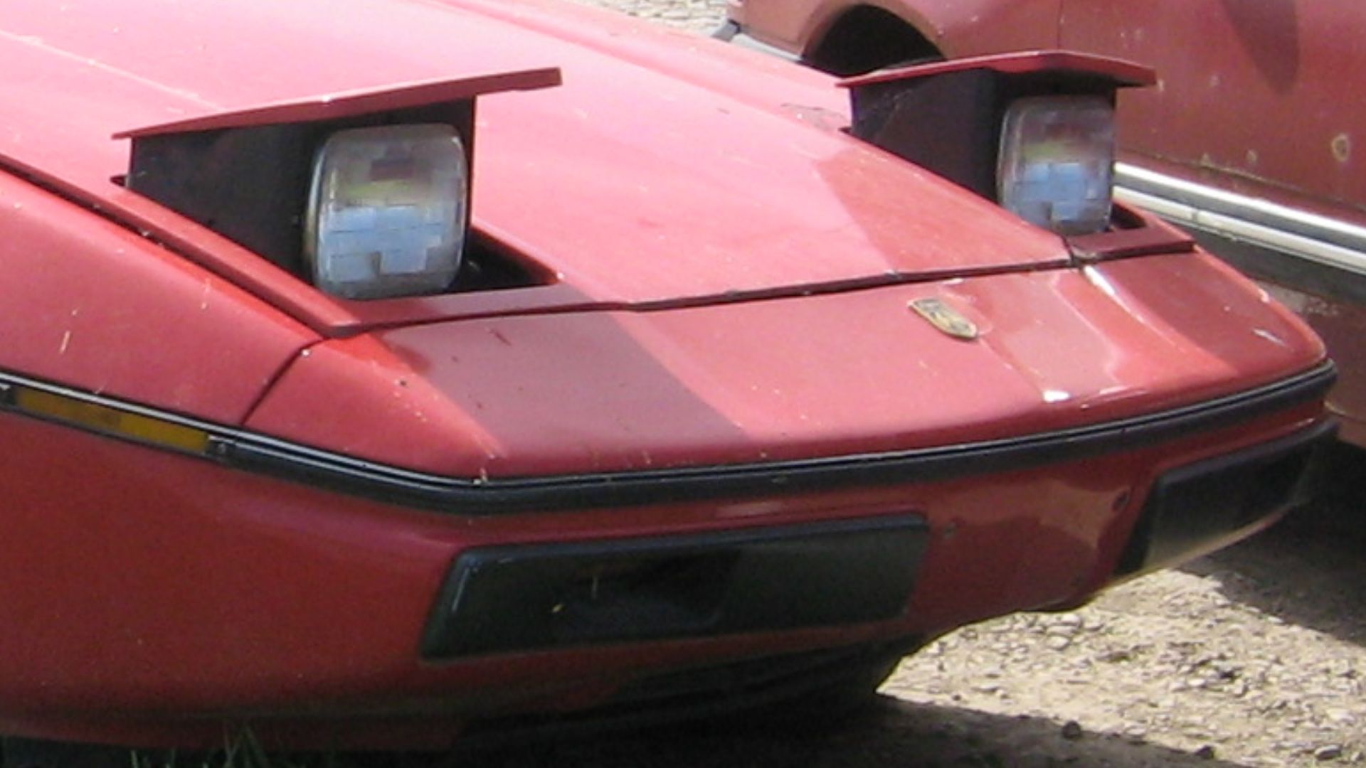 Pontiac Fiero outside the local scrapyard