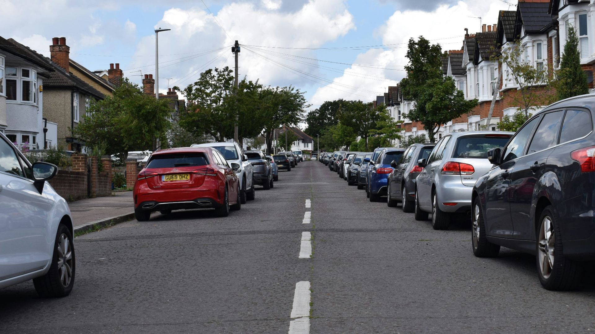 a row of parked cars on a residential street