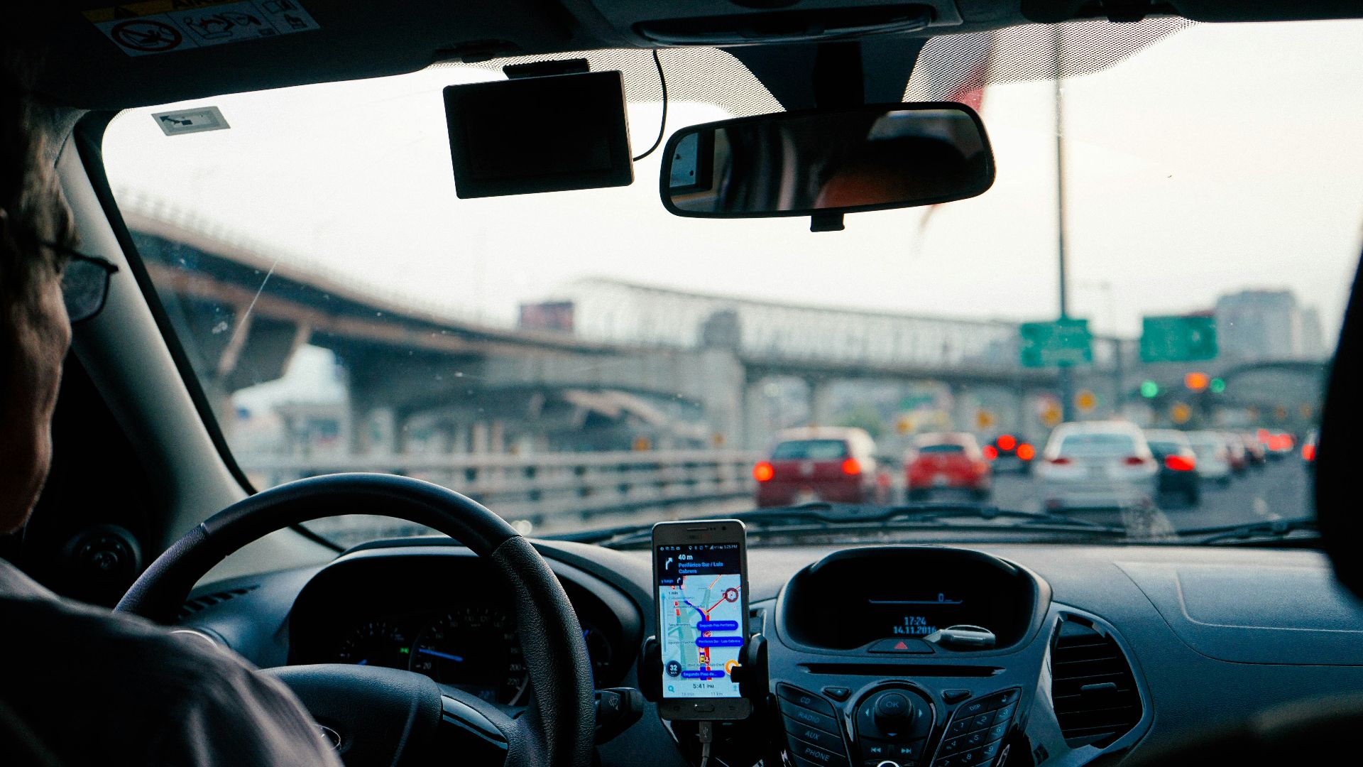 man driving vehicle with GPS system turned on