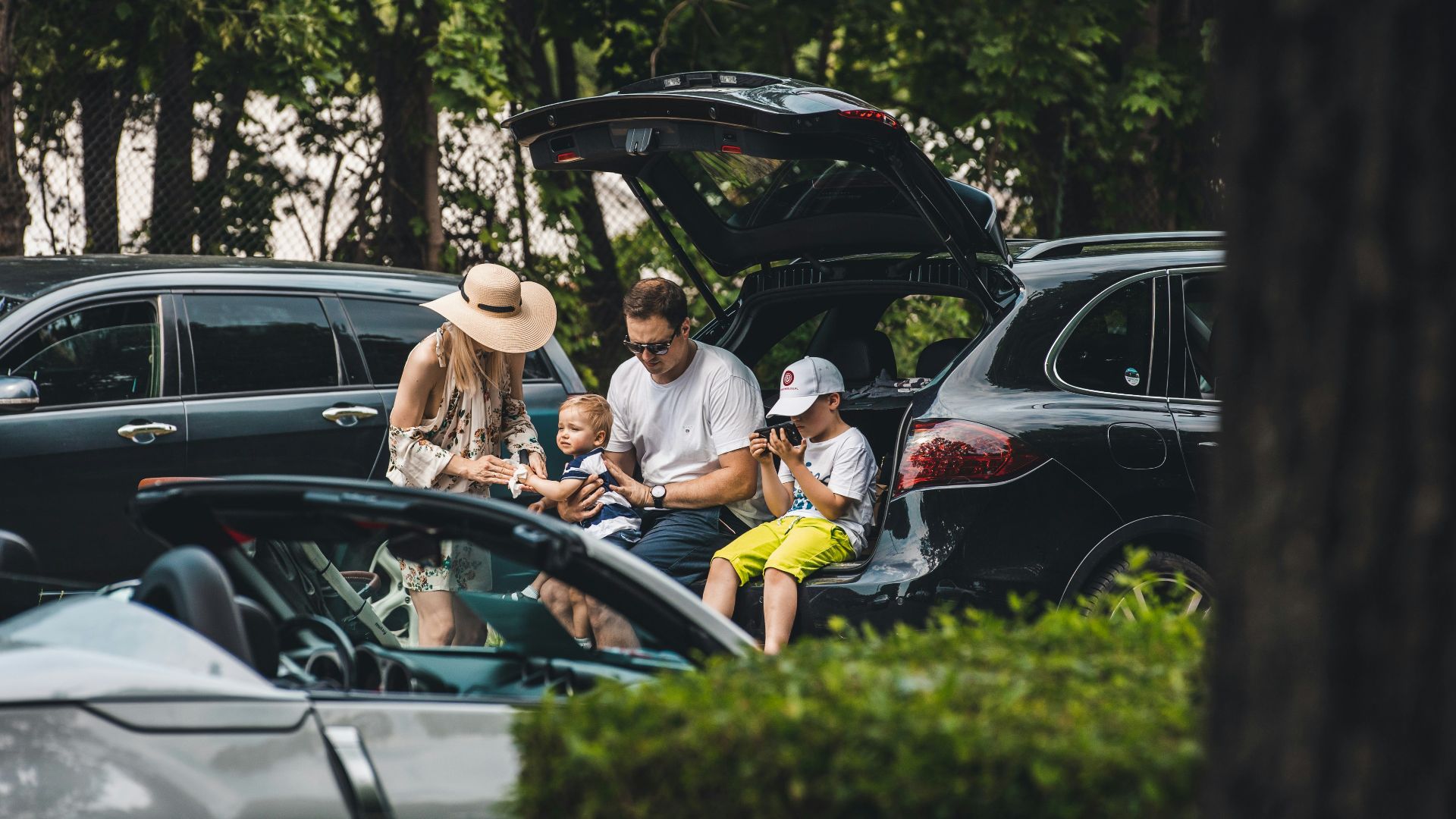 a group of people sitting in the trunk of a car