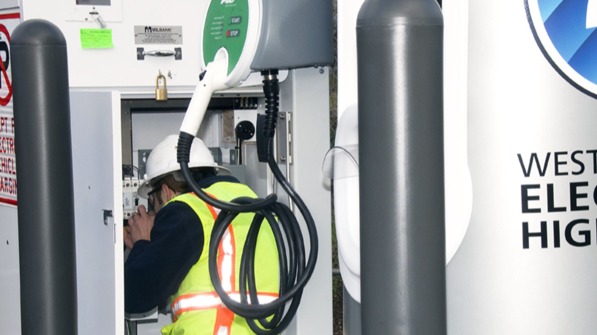 Workers assemble the charging station in Cottage Grove, Oregon at the Vintage Inn.