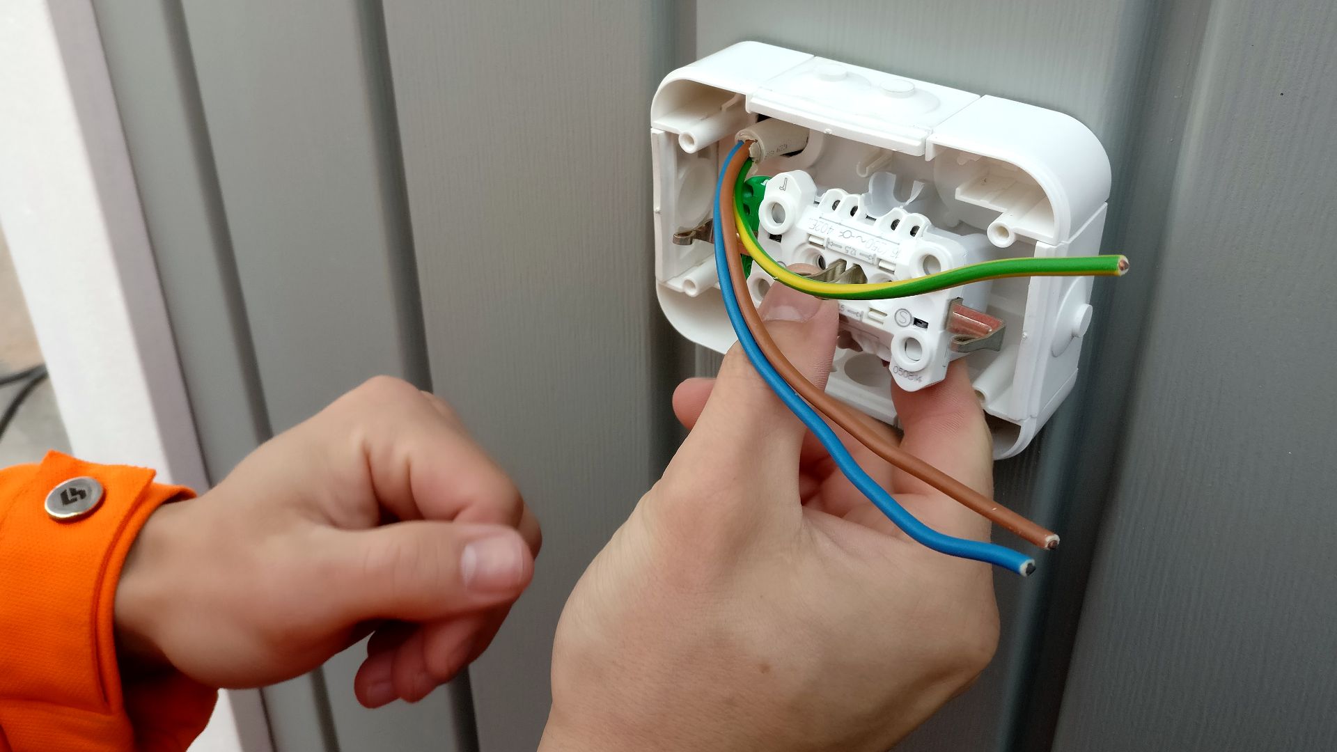 Electrician installing socket.