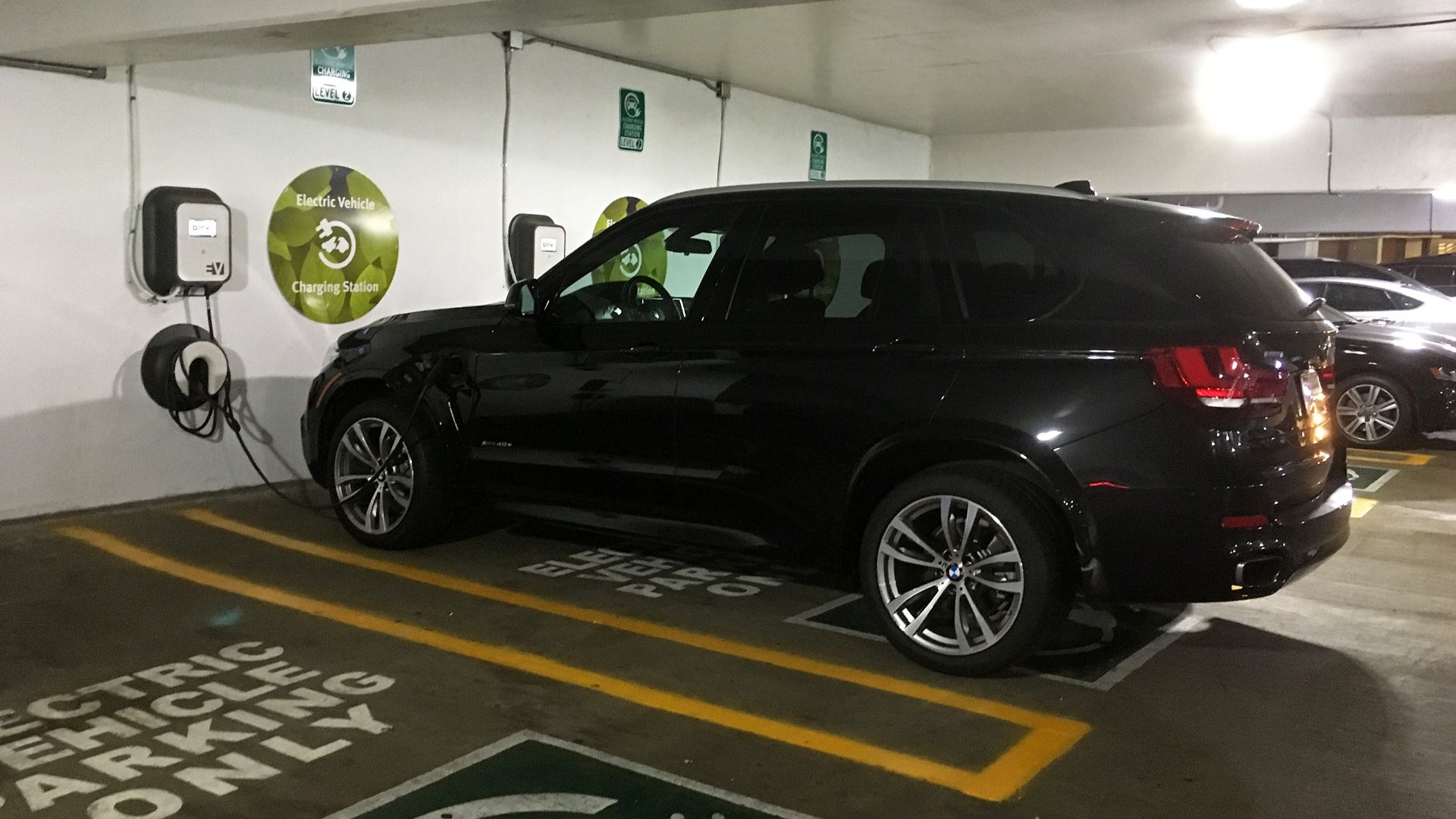 BMW X5 xDrive40e charging at a garage EV charging station at Fashion Centre at Pentagon City, Arlington, Virginia.