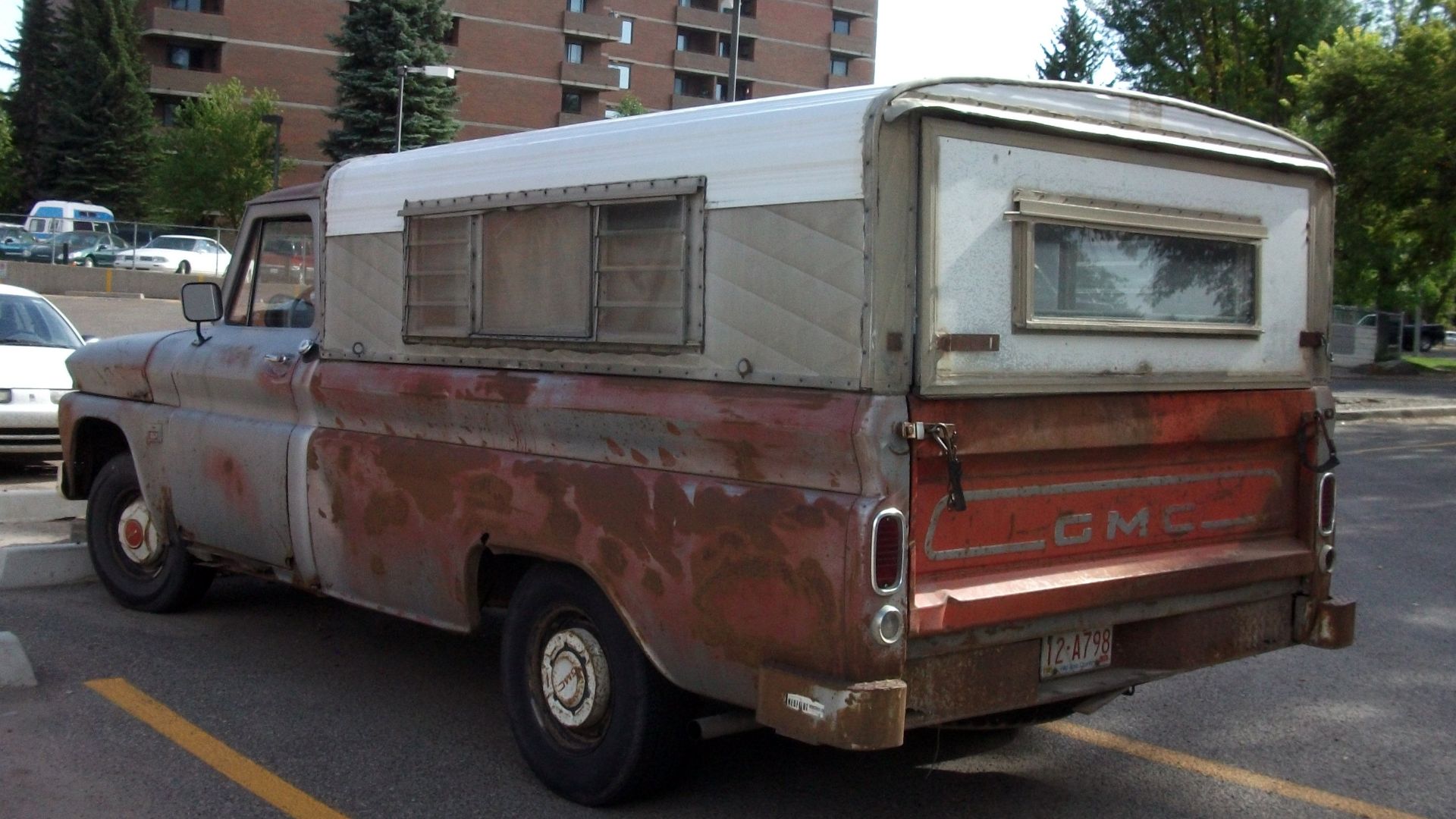 Rusty but running 1966 Chevrolet C10 truck with vintage topper.